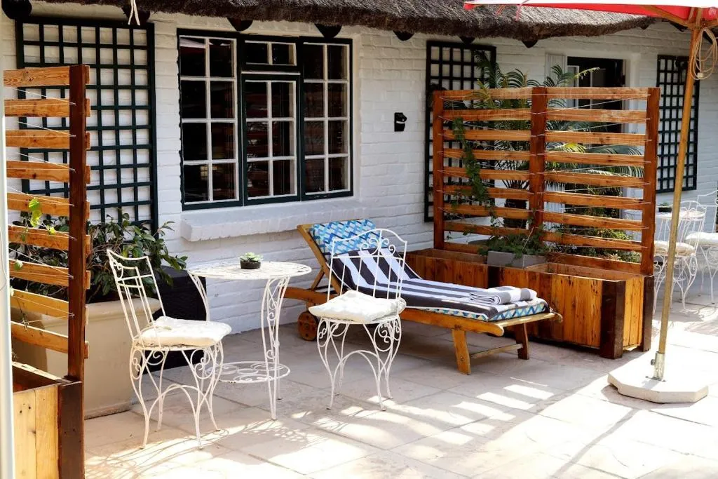 Garden furniture and a lounger outside the rooms