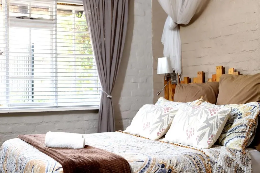 Freshly made bed with folded towels
